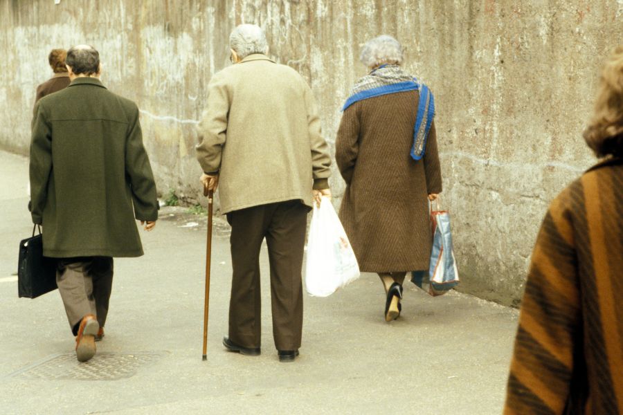 elderly people walking in the cold