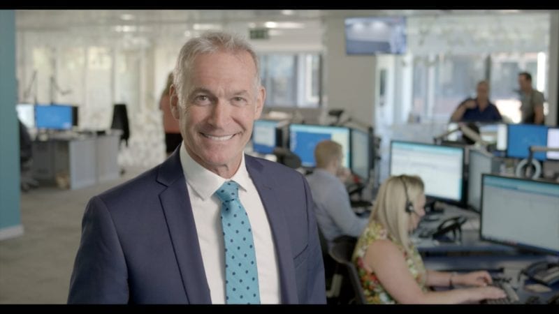 Dr Hilary Jones smiling standing in the Telecare24 office