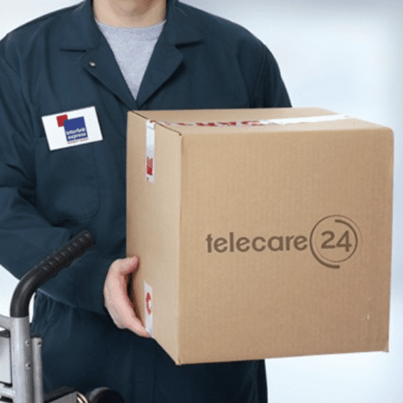 A delivery man holding a package marked with the Telecare24 logo