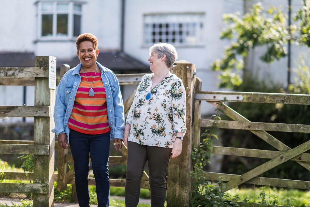 Women outdoors laughing wearing the GO! plan