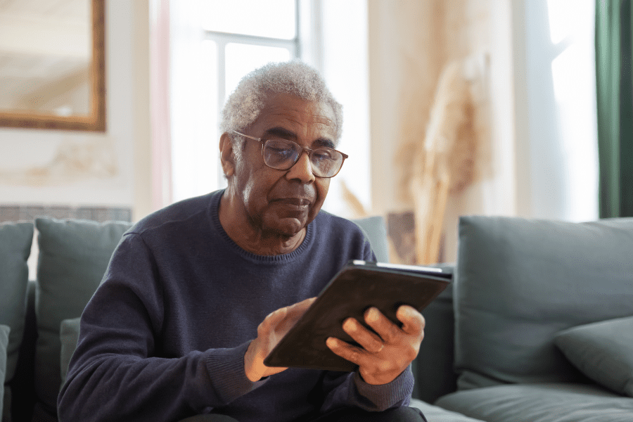Elderly one using a gadget for senior