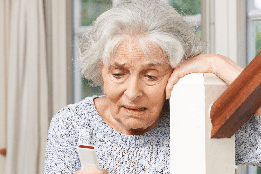 Worried old women with personal alarm