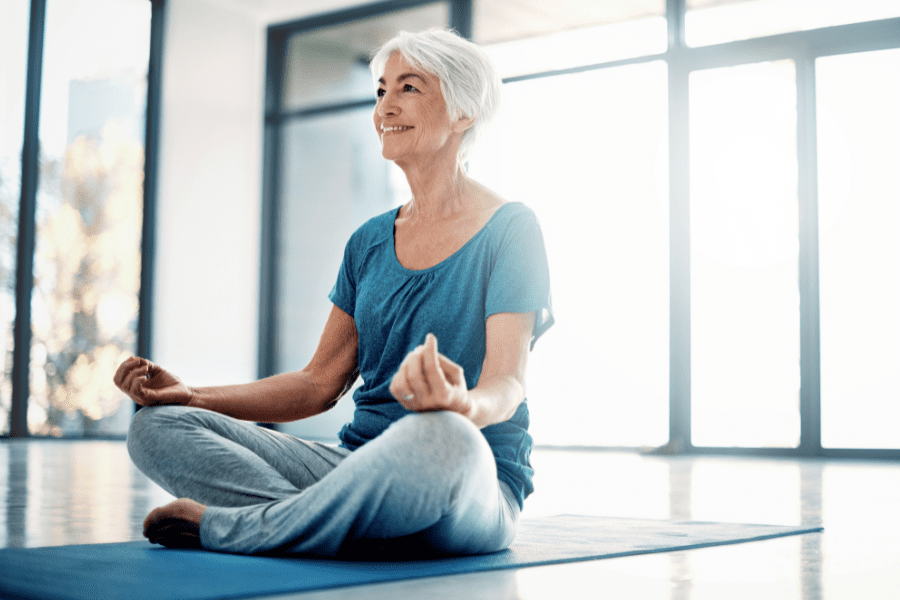 An elderly woman enjoying yoga