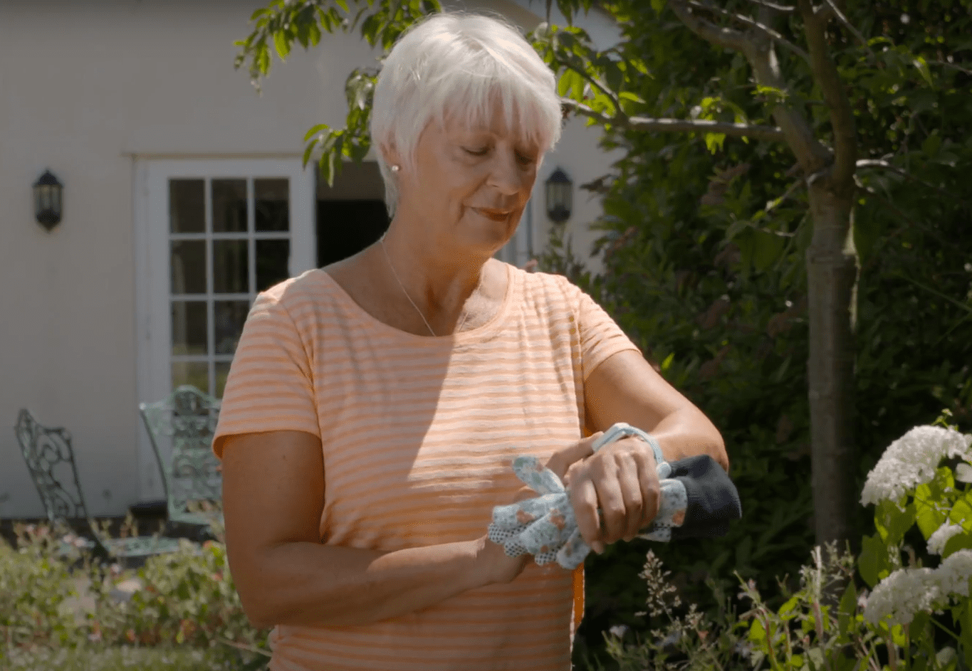 an old woman wearing personal alarm