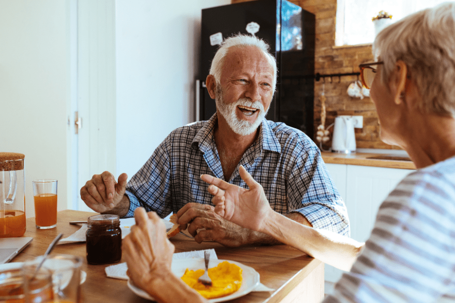 An elderly couple having breakfast