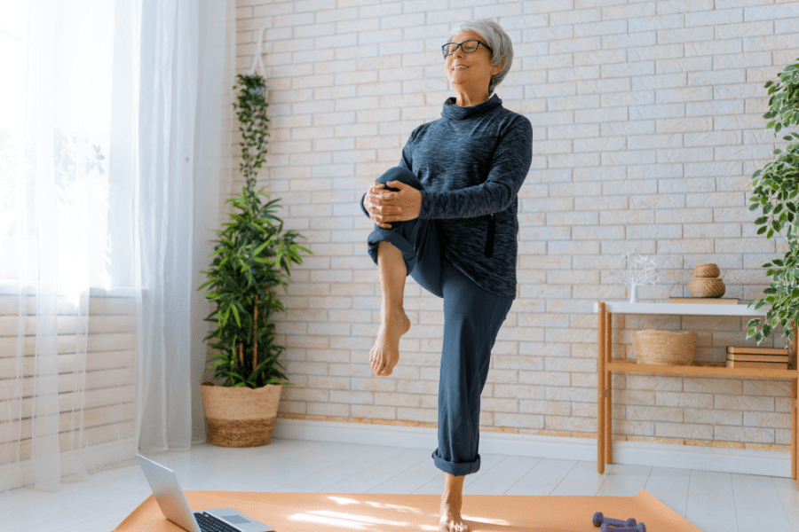 An elderly woman doing home exercise