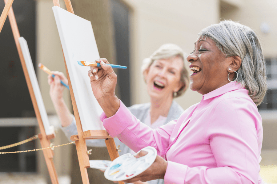 Two elderly women doing painting