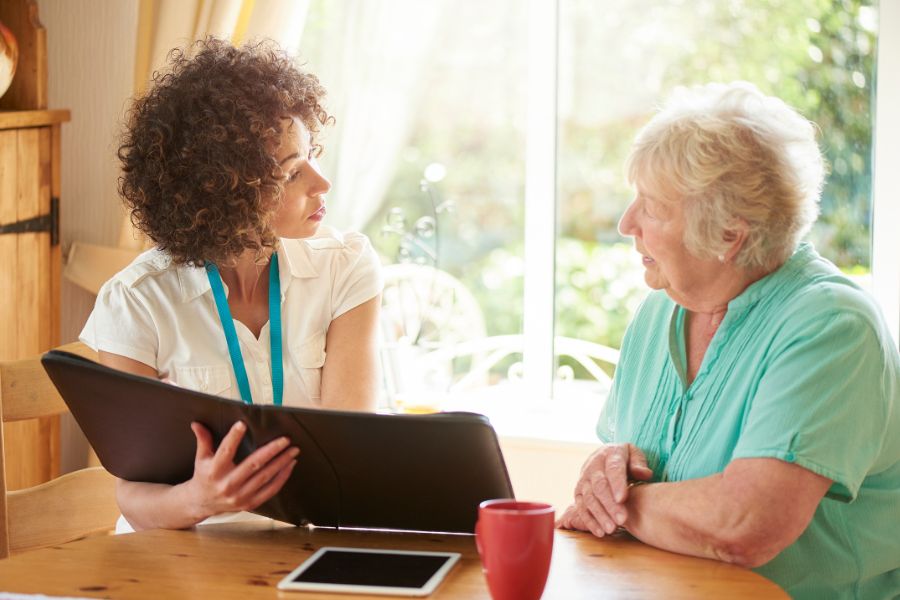 A young girl talking with an old lady about funeral planning