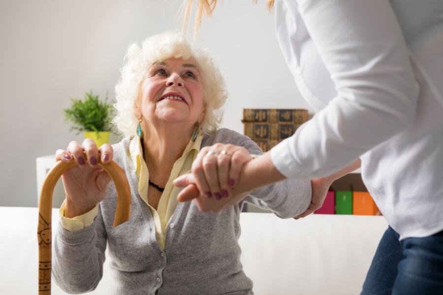 elderly-woman-being-assisted-by-woman
