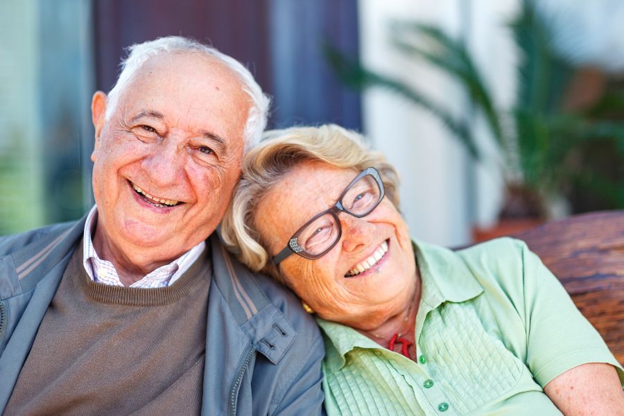 happy-elderly-couple-sitting-together