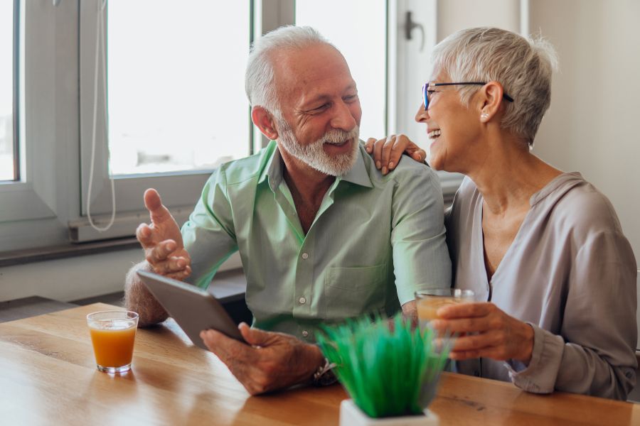 happy-elderly-couple-tablet-juice